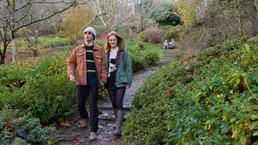 A man and a women walking down the Azalea steps at Winkworth Arboretum